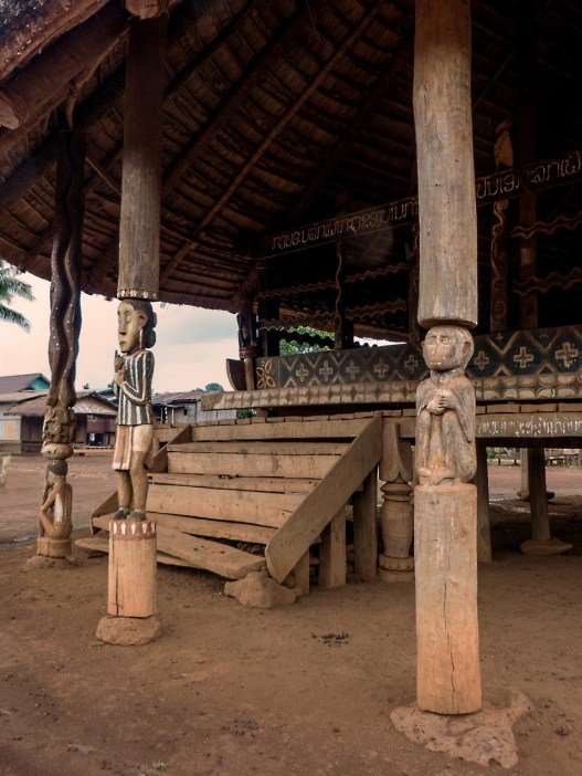 Three pillars in front of the community house all have meaning