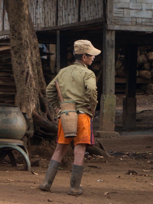Man with basket and knife returning from fields to Katu village