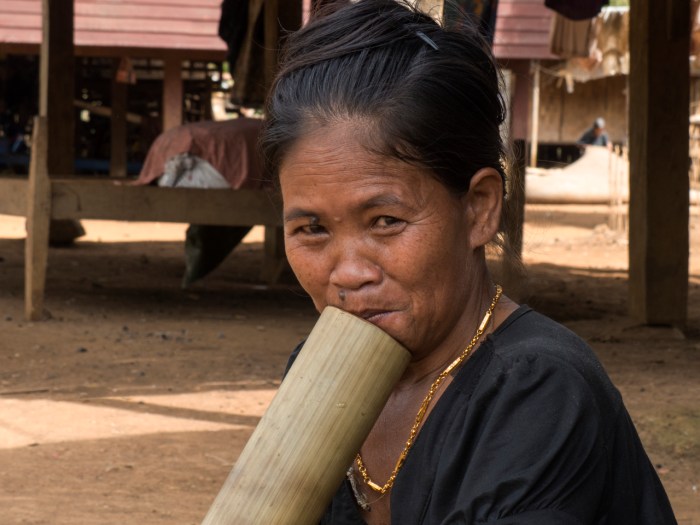 Katu woman smoking a traditional water pipe