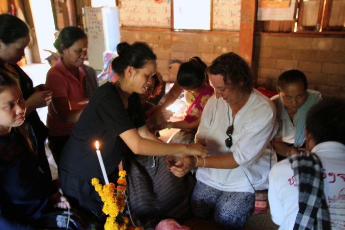 Everyone surrounds us and one at a time tie the string around our wrist