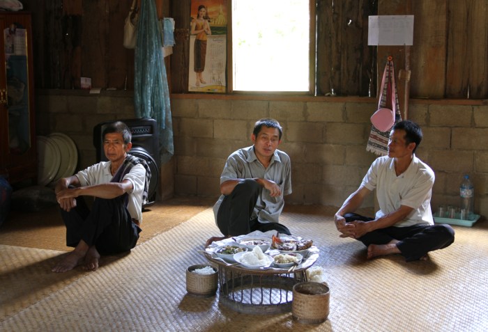 Men sit apart and are served their meal.