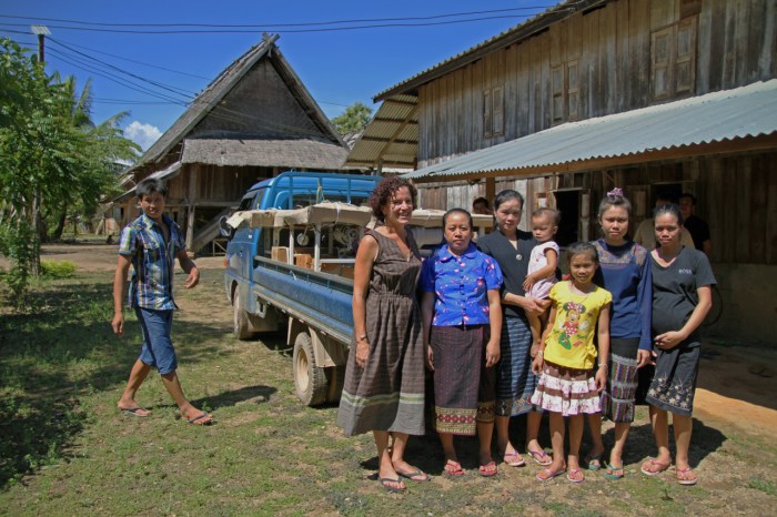 4 women who were trained stand before the truck with Emi