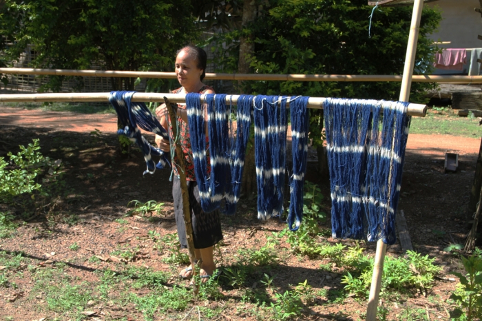 Drying her finished thread that will be used for weaving