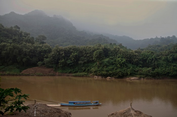 A slow boat heading up the river from Nong Khiaw