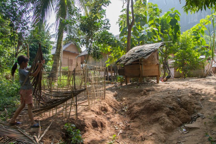 Young girl building a pen for the pigs
