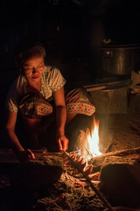 A woman cooking dinner near out hut