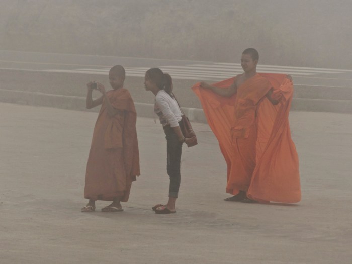Cambodia - 2 Monks and a girl 1000 feet in the fog Bokor